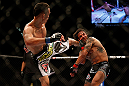 LAS VEGAS, NV - MAY 25:   (L-R) Max Holloway kicks Dennis Bermudez in their featherweight bout during UFC 160 at the MGM Grand Garden Arena on May 25, 2013 in Las Vegas, Nevada.  (Photo by Josh Hedges/Zuffa LLC/Zuffa LLC via Getty Images)  *** Local Caption *** Dennis Bermudez; Max Holloway