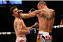 LAS VEGAS, NV - MAY 25:   (R-L) Donald Cerrone punches Karl Noons in their lightweight bout during UFC 160 at the MGM Grand Garden Arena on May 25, 2013 in Las Vegas, Nevada.  (Photo by Josh Hedges/Zuffa LLC/Zuffa LLC via Getty Images)  *** Local Caption *** Donald Cerrone; Karl Noons