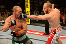 LAS VEGAS, NV - MAY 25:   (R-L) T.J. Grant punches Gray Maynard in their lightweight bout during UFC 160 at the MGM Grand Garden Arena on May 25, 2013 in Las Vegas, Nevada.  (Photo by Donald Miralle/Zuffa LLC/Zuffa LLC via Getty Images)  *** Local Caption *** Gray Maynard; T.J. Grant