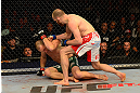 LAS VEGAS, NV - MAY 25:   T.J. Grant (top) punches Gray Maynard in their lightweight bout during UFC 160 at the MGM Grand Garden Arena on May 25, 2013 in Las Vegas, Nevada.  (Photo by Donald Miralle/Zuffa LLC/Zuffa LLC via Getty Images)  *** Local Caption *** Gray Maynard; T.J. Grant