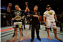 LAS VEGAS, NV - MAY 25:   Cain Velasquez (left) is declared the winner over Antonio Silva (right) in their heavyweight championship bout during UFC 160 at the MGM Grand Garden Arena on May 25, 2013 in Las Vegas, Nevada.  (Photo by Donald Miralle/Zuffa LLC/Zuffa LLC via Getty Images)  *** Local Caption *** Cain Velasquez; Antonio Silva