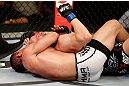 FORTALEZA, BRAZIL - JUNE 08:  (L-R) Caio Magalhaes secures a rear choke submission against Karlos Vemola in their middleweight fight during the UFC on FUEL TV event at Paulo Sarasate Arena on June 8, 2013 in Fortaleza, Ceara, Brazil.  (Photo by Josh Hedges/Zuffa LLC/Zuffa LLC via Getty Images)