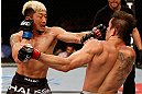 FORTALEZA, BRAZIL - JUNE 08:  (L-R) Mizuto Hirota punches Rodrigo Damm in their featherweight fight during the UFC on FUEL TV event at Paulo Sarasate Arena on June 8, 2013 in Fortaleza, Ceara, Brazil.  (Photo by Josh Hedges/Zuffa LLC/Zuffa LLC via Getty Images)