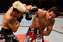 FORTALEZA, BRAZIL - JUNE 08:  (R-L) Rodrigo Damm punches Mizuto Hirota in their featherweight fight during the UFC on FUEL TV event at Paulo Sarasate Arena on June 8, 2013 in Fortaleza, Ceara, Brazil.  (Photo by Josh Hedges/Zuffa LLC/Zuffa LLC via Getty Images)