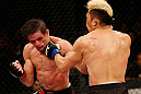 FORTALEZA, BRAZIL - JUNE 08:  (L-R) Rodrigo Damm and Mizuto Hirota trade punches in their featherweight fight during the UFC on FUEL TV event at Paulo Sarasate Arena on June 8, 2013 in Fortaleza, Ceara, Brazil.  (Photo by Josh Hedges/Zuffa LLC/Zuffa LLC via Getty Images)