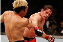 FORTALEZA, BRAZIL - JUNE 08:  (R-L) Rodrigo Damm punches Mizuto Hirota in their featherweight fight during the UFC on FUEL TV event at Paulo Sarasate Arena on June 8, 2013 in Fortaleza, Ceara, Brazil.  (Photo by Josh Hedges/Zuffa LLC/Zuffa LLC via Getty Images)