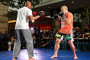 WINNIPEG, CANADA - JUNE 12:  (R-L) Shawn Jordan works out with former CFL football player Lamar McGriggs during an open workout session for fans and media at Portage Place on June 12, 2013 in Winnipeg, Manitoba, Canada.  (Photo by Josh Hedges/Zuffa LLC/Zuffa LLC via Getty Images)