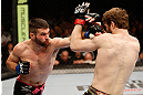 WINNIPEG, CANADA - JUNE 15:  (L-R) John Maguire punches Mitch Clarke in their lightweight fight during the UFC 161 event at the MTS Centre on June 15, 2013 in Winnipeg, Manitoba, Canada.  (Photo by Josh Hedges/Zuffa LLC/Zuffa LLC via Getty Images)