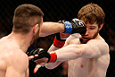 WINNIPEG, CANADA - JUNE 15:  (L-R) John Maguire punches Mitch Clarke in their lightweight fight during the UFC 161 event at the MTS Centre on June 15, 2013 in Winnipeg, Manitoba, Canada.  (Photo by Josh Hedges/Zuffa LLC/Zuffa LLC via Getty Images)