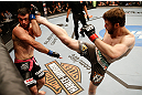 WINNIPEG, CANADA - JUNE 15:  (R-L) Mitch Clarke kicks John Maguire in their lightweight fight during the UFC 161 event at the MTS Centre on June 15, 2013 in Winnipeg, Manitoba, Canada.  (Photo by Josh Hedges/Zuffa LLC/Zuffa LLC via Getty Images)