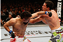 WINNIPEG, CANADA - JUNE 15:  (L-R) Edwin Figueroa punches Roland Delorme in their bantamweight fight during the UFC 161 event at the MTS Centre on June 15, 2013 in Winnipeg, Manitoba, Canada.  (Photo by Josh Hedges/Zuffa LLC/Zuffa LLC via Getty Images)