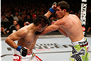 WINNIPEG, CANADA - JUNE 15:  (L-R) Edwin Figueroa punches Roland Delorme in their bantamweight fight during the UFC 161 event at the MTS Centre on June 15, 2013 in Winnipeg, Manitoba, Canada.  (Photo by Josh Hedges/Zuffa LLC/Zuffa LLC via Getty Images)
