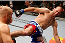 WINNIPEG, CANADA - JUNE 15:  (R-L) Kenny Robertson kicks Sean Pierson in their welterweight fight during the UFC 161 event at the MTS Centre on June 15, 2013 in Winnipeg, Manitoba, Canada.  (Photo by Josh Hedges/Zuffa LLC/Zuffa LLC via Getty Images)