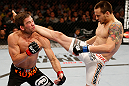 WINNIPEG, CANADA - JUNE 15:  (R-L) James Krause kicks Sam Stout in their lightweight fight during the UFC 161 event at the MTS Centre on June 15, 2013 in Winnipeg, Manitoba, Canada.  (Photo by Josh Hedges/Zuffa LLC/Zuffa LLC via Getty Images)