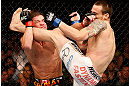 WINNIPEG, CANADA - JUNE 15:  (R-L) James Krause kicks Sam Stout in their lightweight fight during the UFC 161 event at the MTS Centre on June 15, 2013 in Winnipeg, Manitoba, Canada.  (Photo by Josh Hedges/Zuffa LLC/Zuffa LLC via Getty Images)