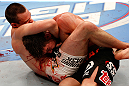 WINNIPEG, CANADA - JUNE 15:  (L-R) James Krause secures a guillotine choke submission against Sam Stout in their lightweight fight during the UFC 161 event at the MTS Centre on June 15, 2013 in Winnipeg, Manitoba, Canada.  (Photo by Josh Hedges/Zuffa LLC/Zuffa LLC via Getty Images)