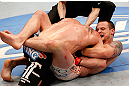 WINNIPEG, CANADA - JUNE 15:  (R-L) James Krause secures a guillotine choke submission against Sam Stout in their lightweight fight during the UFC 161 event at the MTS Centre on June 15, 2013 in Winnipeg, Manitoba, Canada.  (Photo by Josh Hedges/Zuffa LLC/Zuffa LLC via Getty Images)