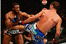 WINNIPEG, CANADA - JUNE 15:  (R-L) Jake Shields kicks Tyron Woodley in their welterweight fight during the UFC 161 event at the MTS Centre on June 15, 2013 in Winnipeg, Manitoba, Canada.  (Photo by Josh Hedges/Zuffa LLC/Zuffa LLC via Getty Images)