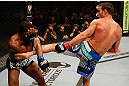 WINNIPEG, CANADA - JUNE 15:  (R-L) Jake Shields kicks Tyron Woodley in their welterweight fight during the UFC 161 event at the MTS Centre on June 15, 2013 in Winnipeg, Manitoba, Canada.  (Photo by Josh Hedges/Zuffa LLC/Zuffa LLC via Getty Images)