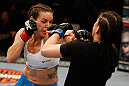 WINNIPEG, CANADA - JUNE 15:  (L-R) Alexis Davis punches Rosi Sexton in their bantamweight fight during the UFC 161 event at the MTS Centre on June 15, 2013 in Winnipeg, Manitoba, Canada.  (Photo by Josh Hedges/Zuffa LLC/Zuffa LLC via Getty Images)
