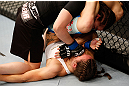 WINNIPEG, CANADA - JUNE 15:  Rosi Sexton (top) punches Alexis Davis as she attempts a triangle choke in their bantamweight fight during the UFC 161 event at the MTS Centre on June 15, 2013 in Winnipeg, Manitoba, Canada.  (Photo by Josh Hedges/Zuffa LLC/Zuffa LLC via Getty Images)