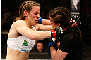WINNIPEG, CANADA - JUNE 15:  (L-R) Alexis Davis and Rosi Sexton trade punches in their bantamweight fight during the UFC 161 event at the MTS Centre on June 15, 2013 in Winnipeg, Manitoba, Canada.  (Photo by Josh Hedges/Zuffa LLC/Zuffa LLC via Getty Images)