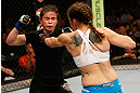 WINNIPEG, CANADA - JUNE 15:  (R-L) Alexis Davis punches Rosi Sexton in their bantamweight fight during the UFC 161 event at the MTS Centre on June 15, 2013 in Winnipeg, Manitoba, Canada.  (Photo by Josh Hedges/Zuffa LLC/Zuffa LLC via Getty Images)