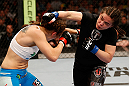 WINNIPEG, CANADA - JUNE 15:  (R-L) Rosi Sexton punches Alexis Davis in their bantamweight fight during the UFC 161 event at the MTS Centre on June 15, 2013 in Winnipeg, Manitoba, Canada.  (Photo by Josh Hedges/Zuffa LLC/Zuffa LLC via Getty Images)