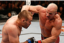 WINNIPEG, CANADA - JUNE 15:  (R-L) Ryan Jimmo punches Igor Pokrajac in their light heavyweight fight during the UFC 161 event at the MTS Centre on June 15, 2013 in Winnipeg, Manitoba, Canada.  (Photo by Josh Hedges/Zuffa LLC/Zuffa LLC via Getty Images)