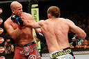 WINNIPEG, CANADA - JUNE 15:  (R-L) Igor Pokrajac punches Ryan Jimmo in their light heavyweight fight during the UFC 161 event at the MTS Centre on June 15, 2013 in Winnipeg, Manitoba, Canada.  (Photo by Josh Hedges/Zuffa LLC/Zuffa LLC via Getty Images)