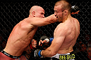WINNIPEG, CANADA - JUNE 15:  (L-R) Ryan Jimmo punches Igor Pokrajac in their light heavyweight fight during the UFC 161 event at the MTS Centre on June 15, 2013 in Winnipeg, Manitoba, Canada.  (Photo by Josh Hedges/Zuffa LLC/Zuffa LLC via Getty Images)