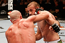 WINNIPEG, CANADA - JUNE 15:  (L-R) Ryan Jimmo punches Igor Pokrajac in their light heavyweight fight during the UFC 161 event at the MTS Centre on June 15, 2013 in Winnipeg, Manitoba, Canada.  (Photo by Josh Hedges/Zuffa LLC/Zuffa LLC via Getty Images)