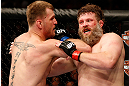WINNIPEG, CANADA - JUNE 15:  (L-R) Stipe Miocic elbows "Big Country" Roy Nelson in their heavyweight fight during the UFC 161 event at the MTS Centre on June 15, 2013 in Winnipeg, Manitoba, Canada.  (Photo by Josh Hedges/Zuffa LLC/Zuffa LLC via Getty Images)