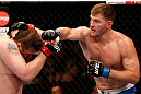 WINNIPEG, CANADA - JUNE 15:  (R-L) Stipe Miocic punches "Big Country" Roy Nelson in their heavyweight fight during the UFC 161 event at the MTS Centre on June 15, 2013 in Winnipeg, Manitoba, Canada.  (Photo by Josh Hedges/Zuffa LLC/Zuffa LLC via Getty Images)