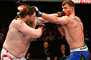 WINNIPEG, CANADA - JUNE 15:  (L-R) "Big Country" Roy Nelson and Stipe Miocic trade punches in their heavyweight fight during the UFC 161 event at the MTS Centre on June 15, 2013 in Winnipeg, Manitoba, Canada.  (Photo by Josh Hedges/Zuffa LLC/Zuffa LLC via Getty Images)