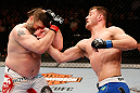 WINNIPEG, CANADA - JUNE 15:  (R-L) Stipe Miocic punches "Big Country" Roy Nelson in their heavyweight fight during the UFC 161 event at the MTS Centre on June 15, 2013 in Winnipeg, Manitoba, Canada.  (Photo by Josh Hedges/Zuffa LLC/Zuffa LLC via Getty Images)