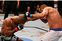 WINNIPEG, CANADA - JUNE 15:  (L-R) Rashad Evans punches Dan Henderson in their light heavyweight fight during the UFC 161 event at the MTS Centre on June 15, 2013 in Winnipeg, Manitoba, Canada.  (Photo by Josh Hedges/Zuffa LLC/Zuffa LLC via Getty Images)