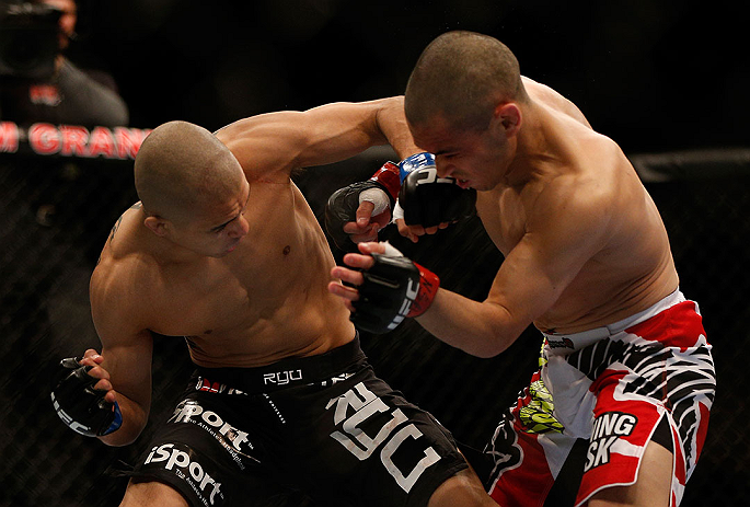 LAS VEGAS, NV - DECEMBER 29:  (L-R) John Moraga punches Chris Cariaso during their flyweight fight at UFC 155 on December 29, 2012 at MGM Grand Garden Arena in Las Vegas, Nevada. (Photo by Josh Hedges/Zuffa LLC/Zuffa LLC via Getty Images) *** Local Caption *** Chris Cariaso; John Moraga