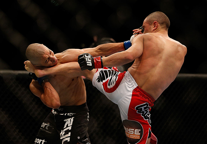 LAS VEGAS, NV - DECEMBER 29:  (R-L) Chris Cariaso kicks John Moraga during their flyweight fight at UFC 155 on December 29, 2012 at MGM Grand Garden Arena in Las Vegas, Nevada. (Photo by Josh Hedges/Zuffa LLC/Zuffa LLC via Getty Images) *** Local Caption *** Chris Cariaso; John Moraga