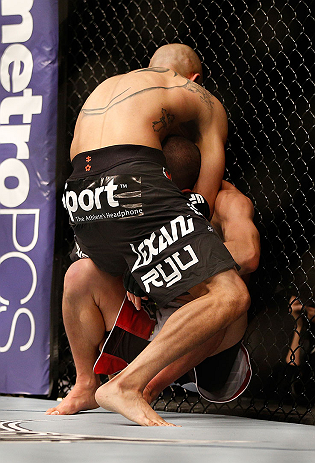 LAS VEGAS, NV - DECEMBER 29:  John Moraga (black shorts) attempts to submit Chris Cariaso during their flyweight fight at UFC 155 on December 29, 2012 at MGM Grand Garden Arena in Las Vegas, Nevada. (Photo by Josh Hedges/Zuffa LLC/Zuffa LLC via Getty Images) *** Local Caption *** Chris Cariaso; John Moraga