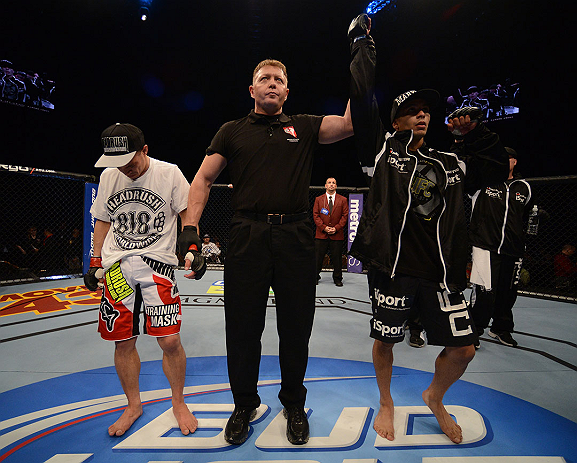 LAS VEGAS, NV - DECEMBER 29:  John Moraga (right) is declared the winner over Chris Cariaso (left) after their flyweight fight at UFC 155 on December 29, 2012 at MGM Grand Garden Arena in Las Vegas, Nevada. (Photo by Donald Miralle/Zuffa LLC/Zuffa LLC via Getty Images) *** Local Caption *** Chris Cariaso; John Moraga