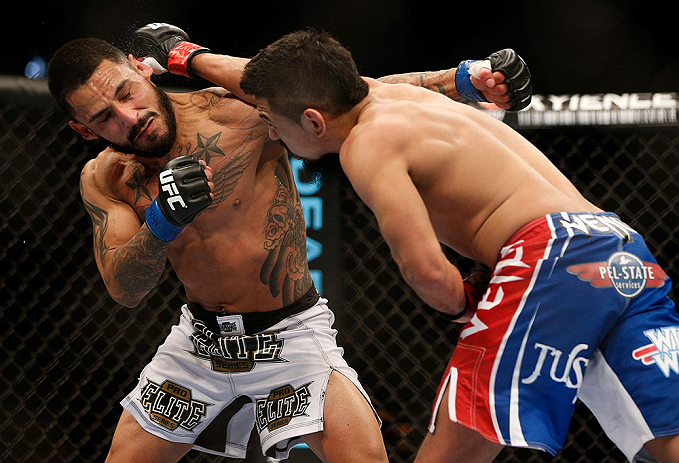 LAS VEGAS, NV - FEBRUARY 02: Edwin Figueroa (right) punches Francisco Rivera during their bantamweight fight at UFC 156 on February 2, 2013 at the Mandalay Bay Events Center in Las Vegas, Nevada. (Photo by Josh Hedges/Zuffa LLC/Zuffa LLC via Getty Images) *** Local Caption *** Francisco Rivera; Edwin Figueroa