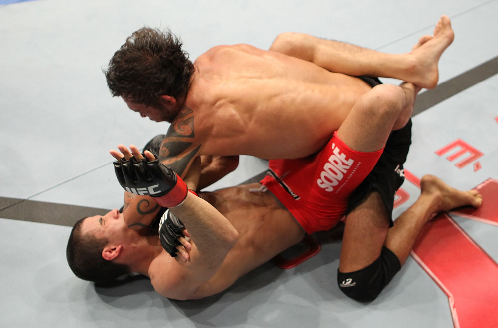 BELO HORIZONTE, BRAZIL - JUNE 23: (R-L) Milton Vieira delivers an elbow against Felipe Arantes during their UFC 147 featherweight bout at Estadio Jornalista Felipe Drummond on June 23, 2012 in Belo Horizonte, Brazil. (Photo by Josh Hedges/Zuffa LLC/Zuffa LLC via Getty Images)