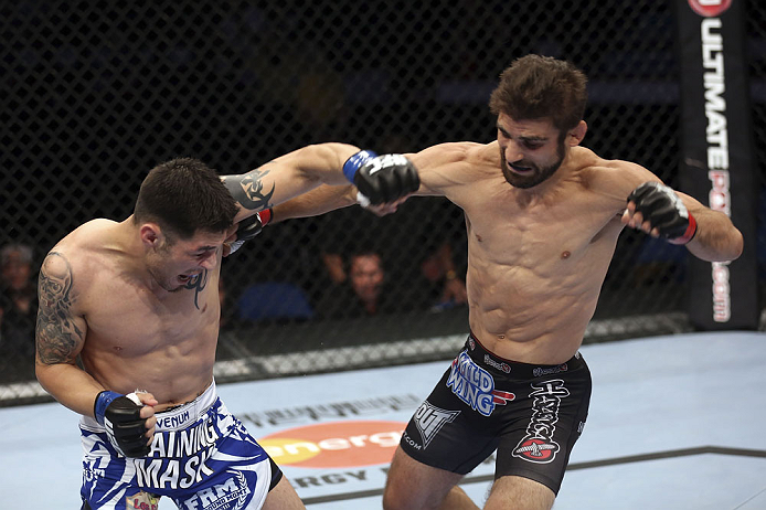 CALGARY, CANADA - JULY 21: (R-L) Antonio Carvalho lands a punch on Daniel Pineda during their featherweight bout at UFC 149 inside the Scotiabank Saddledome on July 21, 2012 in Calgary, Alberta, Canada.  (Photo by Nick Laham/Zuffa LLC/Zuffa LLC via Getty Images)