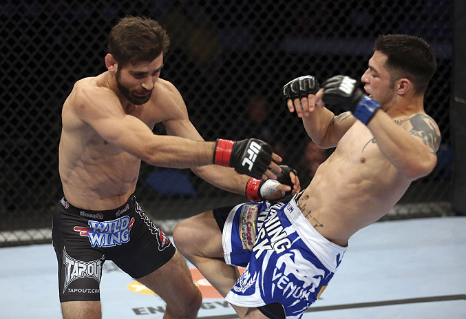 CALGARY, CANADA - JULY 21: (L-R) Antonio Carvalho exchanges punches with Daniel Pineda during their featherweight bout at UFC 149 inside the Scotiabank Saddledome on July 21, 2012 in Calgary, Alberta, Canada.  (Photo by Nick Laham/Zuffa LLC/Zuffa LLC via Getty Images)