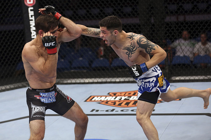 CALGARY, CANADA - JULY 21: (R-L) Daniel Pineda throws a punch at Antonio Carvalho during their featherweight bout at UFC 149 inside the Scotiabank Saddledome on July 21, 2012 in Calgary, Alberta, Canada.  (Photo by Nick Laham/Zuffa LLC/Zuffa LLC via Getty Images)