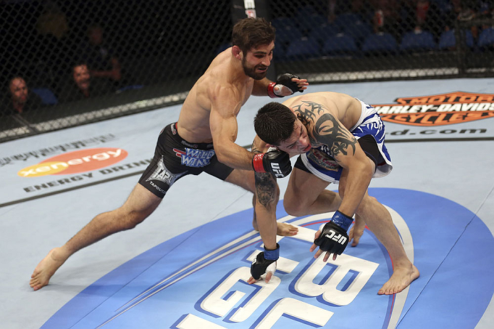 CALGARY, CANADA - JULY 21: (L-R) Antonio Carvalho lands a knockout punch on Daniel Pineda during their featherweight bout at UFC 149 inside the Scotiabank Saddledome on July 21, 2012 in Calgary, Alberta, Canada.  (Photo by Nick Laham/Zuffa LLC/Zuffa LLC via Getty Images)