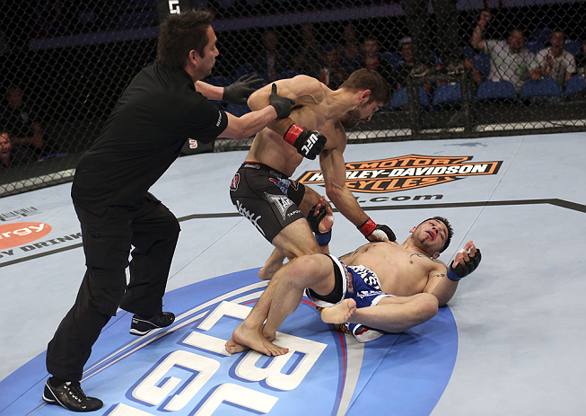 CALGARY, CANADA - JULY 21:  (L-R) Referee Mario Yamasaki pulls Antonio Carvalho off Daniel Pineda after a knockout punch during their featherweight bout at UFC 149 inside the Scotiabank Saddledome on July 21, 2012 in Calgary, Alberta, Canada.  (Photo by Nick Laham/Zuffa LLC/Zuffa LLC via Getty Images)