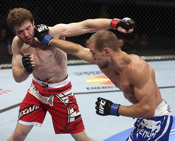 CALGARY, CANADA - JULY 21: (R-L) Anton Kuivanen lands a punch on Mitch Clarke during their lightweight bout at UFC 149 inside the Scotiabank Saddledome on July 21, 2012 in Calgary, Alberta, Canada.  (Photo by Nick Laham/Zuffa LLC/Zuffa LLC via Getty Images)
