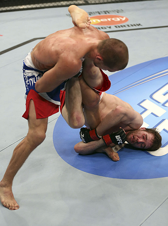 CALGARY, CANADA - JULY 21: (R-L) Mitch Clarke wraps around the leg of Anton Kuivanen during their lightweight bout at UFC 149 inside the Scotiabank Saddledome on July 21, 2012 in Calgary, Alberta, Canada.  (Photo by Nick Laham/Zuffa LLC/Zuffa LLC via Getty Images)